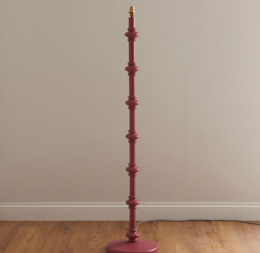 Make a bold statement with this exquisite wooden floor lamp in a rich Satin Pink finish. The turned wood spindle design exudes elegance, while brass detailing adds a touch of sophistication. Perfect for modern, vintage, or eclectic interiors, this lamp enhances any space with its distinctive charm.